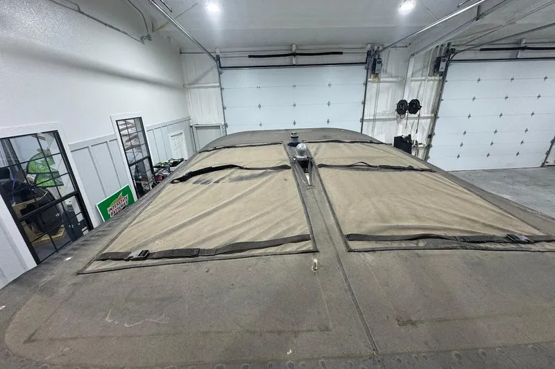 Slide: The Image of 2007 Malibu Wakesetter 23 LSV covered in a garage, showcasing storage setup. - 21