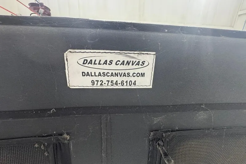 Slide: The Image of Dallas Canvas label on black fabric, featuring contact details and website. - 22