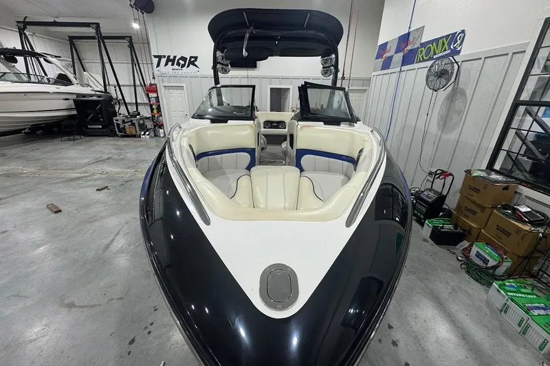 Slide: The Image of 2007 Malibu Wakesetter 23 LSV boat in a garage, showcasing sleek design and spacious seating. - 29