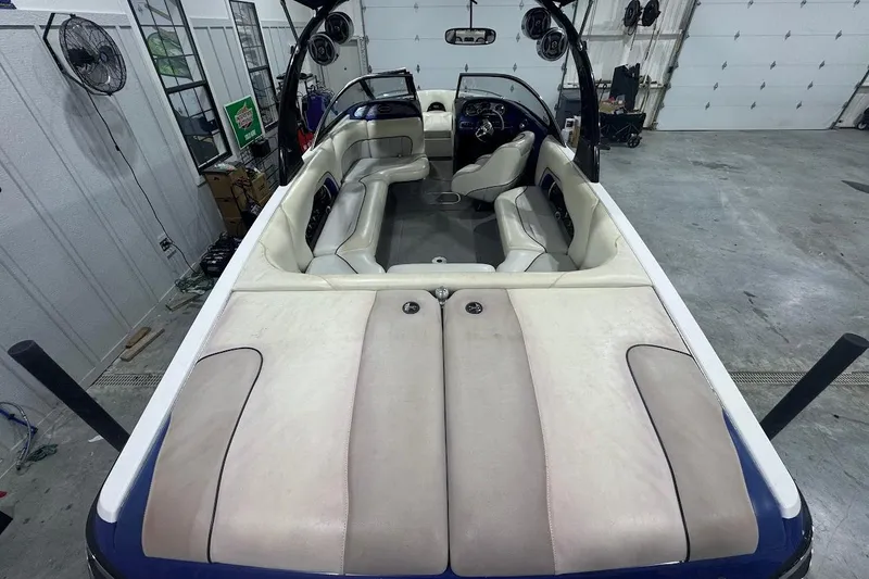 Slide: The Image of 2007 Malibu Wakesetter 23 LSV interior with beige seating in a garage setting. - 31