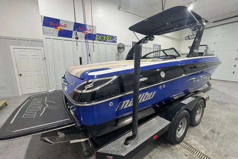 Slide: The Image of 2007 Malibu Wakesetter 23 LSV boat in garage, blue and black design. - 5