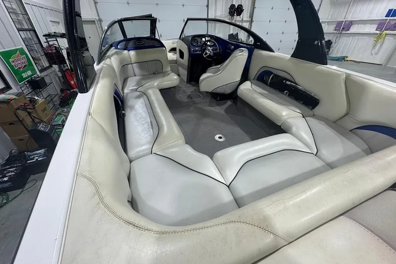 Slide: The Image of 2007 Malibu Wakesetter 23 LSV interior with white seating in a garage setting. - 9