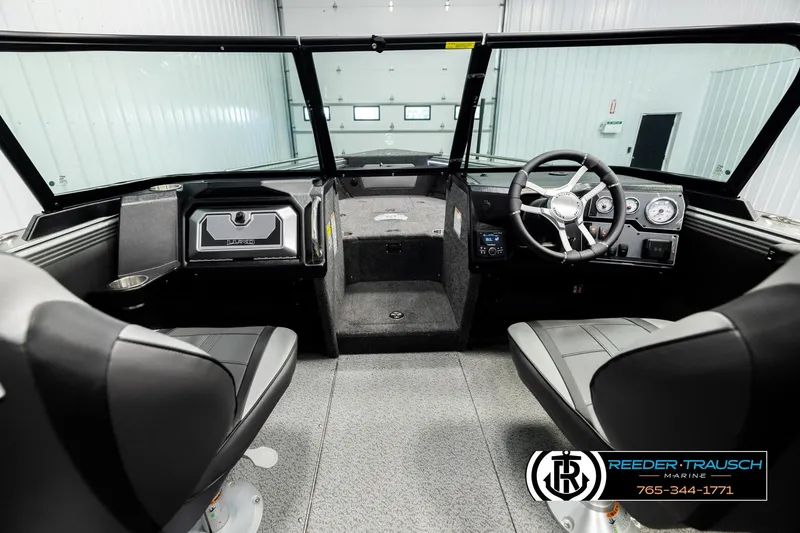 Slide: The Image of Interior of 2026 Lund 1975 Tyee boat with steering wheel and seating. - 13