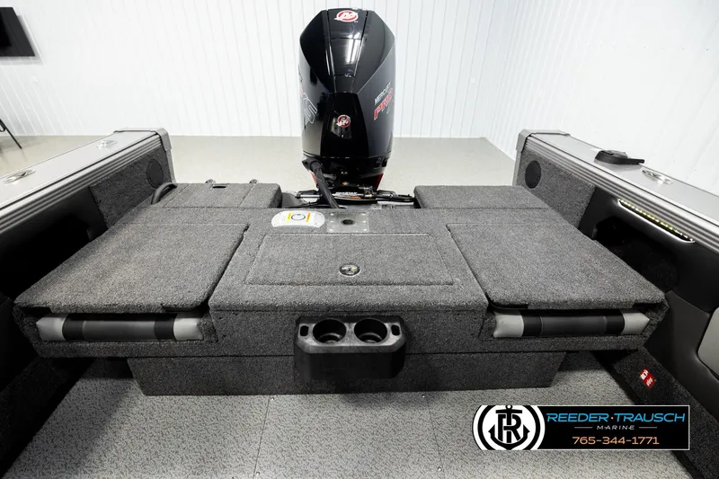 Slide: The Image of 2026 Lund 1975 Tyee boat interior with Mercury engine, featuring cushioned seating and storage. - 21