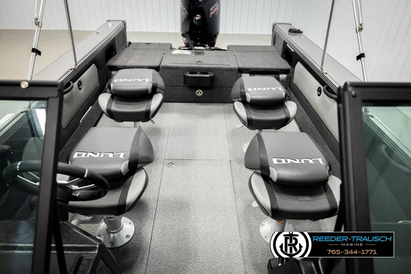 Slide: The Image of Interior of 2026 Lund 1975 Tyee boat with four cushioned seats and steering wheel. - 22