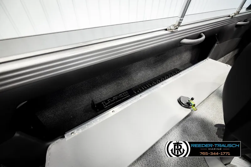 Slide: The Image of Interior of 2026 Lund 1975 Tyee boat with storage compartment and measuring tool. - 27