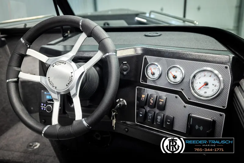 Slide: The Image of Interior of 2026 Lund 1975 Tyee boat with steering wheel and dashboard controls. - 36
