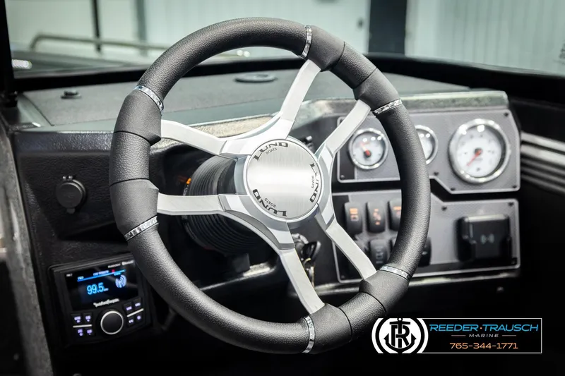 Slide: The Image of Steering wheel of 2026 Lund 1975 Tyee boat with dashboard controls and gauges. - 37