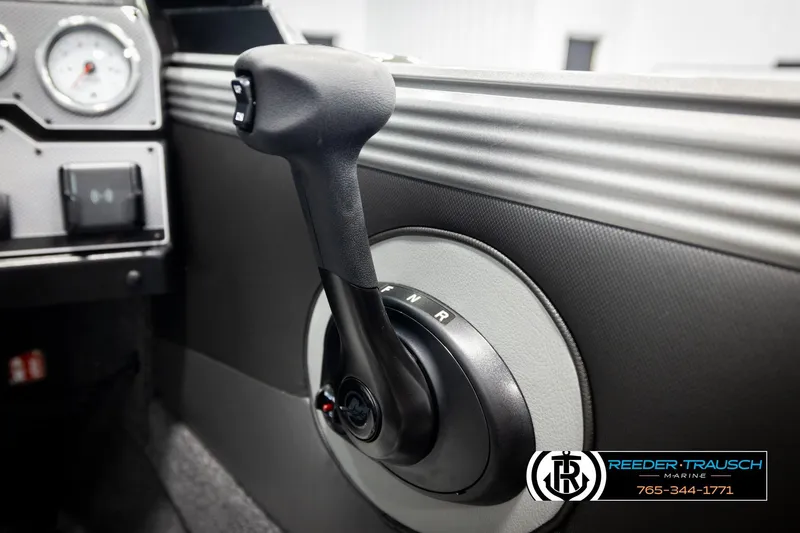 Slide: The Image of 2026 Lund 1975 Tyee boat control panel with gear shift lever, featuring Reeder-Trausch Marine branding. - 43