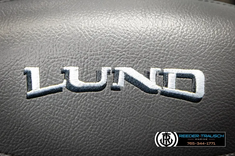 Slide: The Image of Lund 1975 Tyee 2026 logo on textured gray surface, Reeder-Trausch Marine branding. - 46