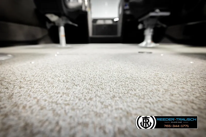 Slide: The Image of Carpeted interior of 2026 Lund 1975 Tyee boat, featuring Reeder-Trausch Marine branding. - 50