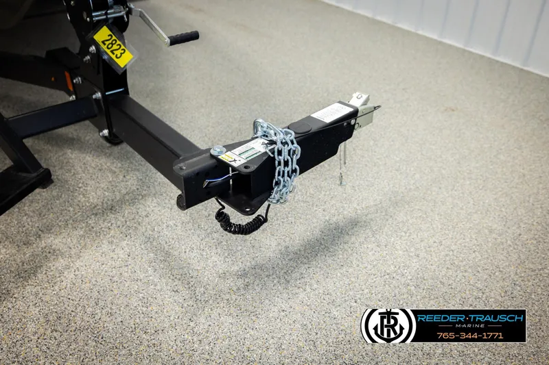 Slide: The Image of Trailer hitch of 2026 Lund 1975 Tyee with safety chain on showroom floor. - 56