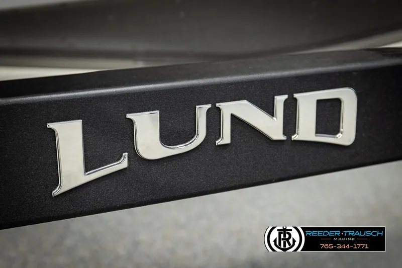 Slide: The Image of Chrome "Lund" logo on 2026 Lund 1975 Tyee boat, Reeder-Trausch Marine branding. - 58
