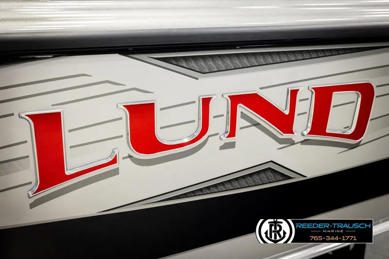 Slide: The Image of Close-up of 2026 Lund 1975 Tyee boat logo with Reeder-Trausch Marine branding. - 59
