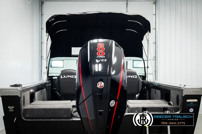 Slide: The Image of 2026 Lund 1975 Tyee boat with powerful V8 engine in a showroom. - 6