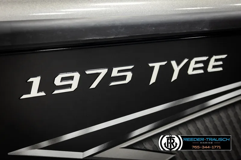 Slide: The Image of Close-up of 2026 Lund 1975 Tyee boat model name on black surface. - 60