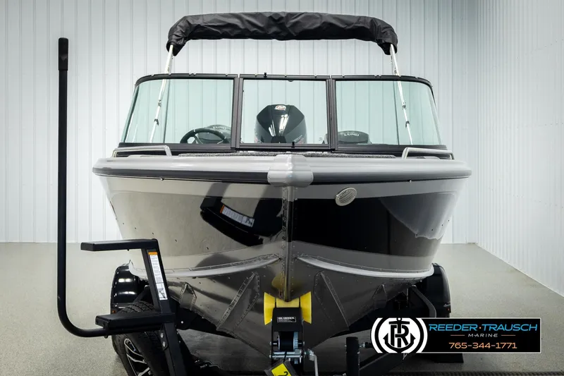 Slide: The Image of 2026 Lund 1975 Tyee boat in showroom, front view, with trailer and canopy. - 7