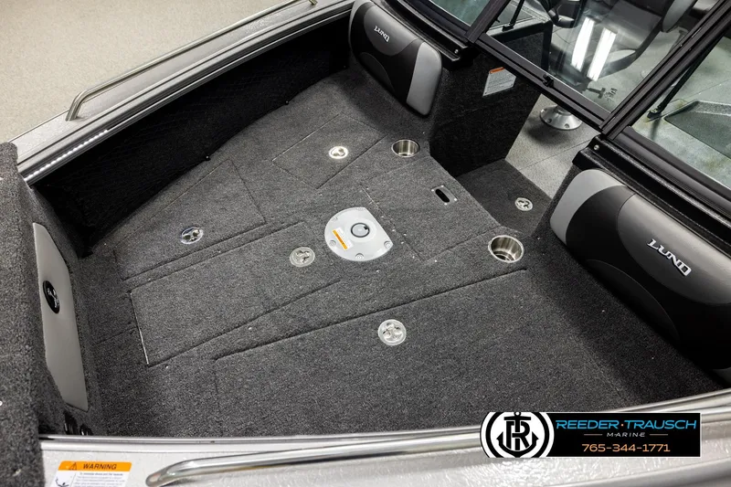 Slide: The Image of Interior of 2026 Lund 1975 Tyee boat with carpeted flooring and seating. - 9