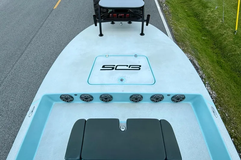Slide: The Image of 2020 SCB R24 boat on road, featuring deck speakers and logo. - 12