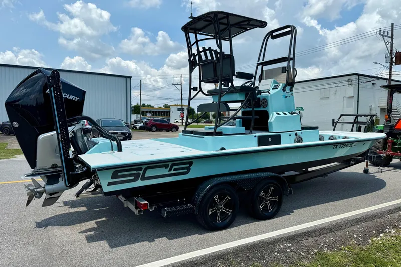 Slide: The Image of 2020 SCB R24 boat with Mercury engine on trailer, parked outdoors. - 4