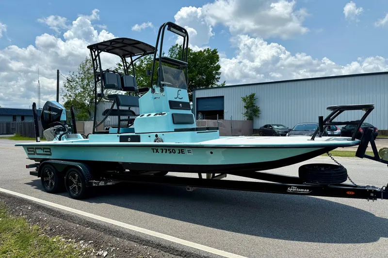 Slide: The Image of 2020 SCB R24 boat on trailer, parked outdoors under cloudy sky. - 5