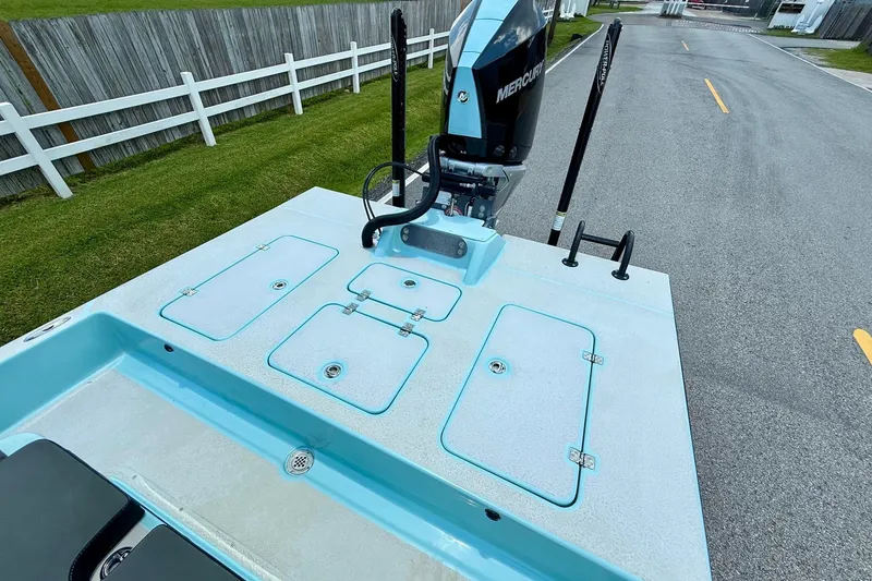 Slide: The Image of 2020 SCB R24 boat with Mercury engine, featuring storage compartments and sleek design. - 7