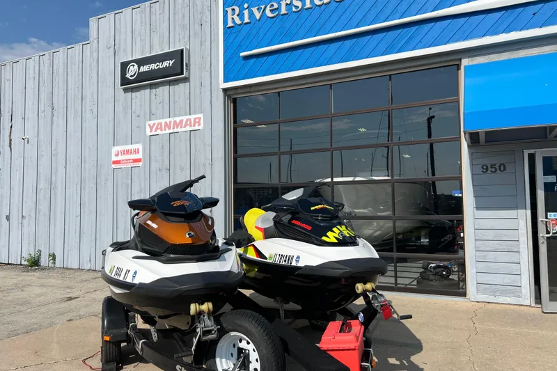 Slide: The Image of 2015 Sea-Doo Wake Pro 215 jet skis outside dealership with Mercury and Yamaha signs. - 0