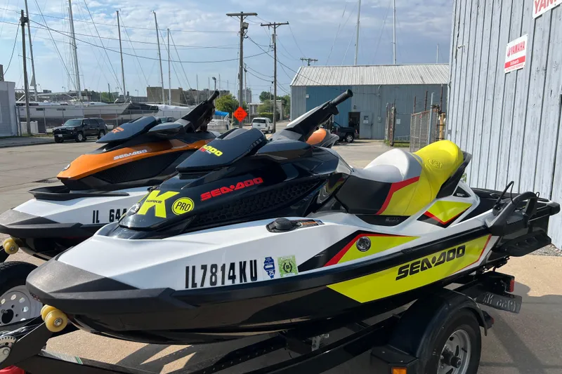 Slide: The Image of 2015 Sea-Doo Wake Pro 215 jet skis parked on a trailer, ready for adventure. - 1