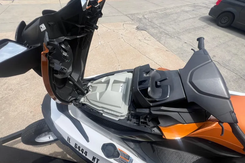 Slide: The Image of 2015 Sea-Doo Wake Pro 215 with open storage compartment, parked on concrete. - 12