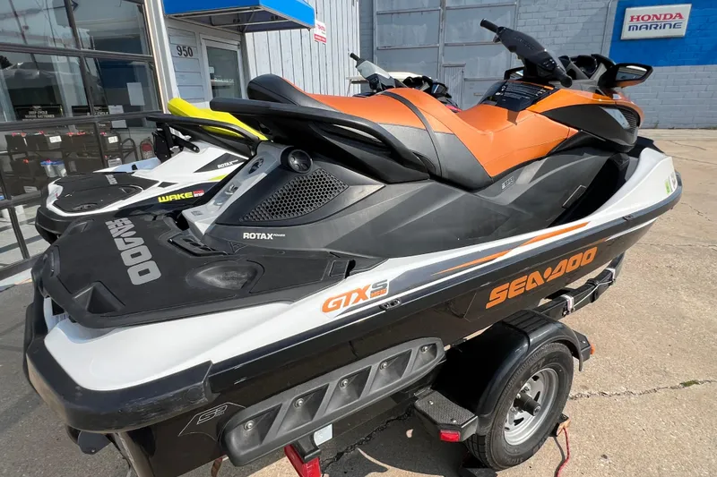 Slide: The Image of 2015 Sea-Doo Wake Pro 215 jet ski on trailer, parked outside Honda Marine. - 14
