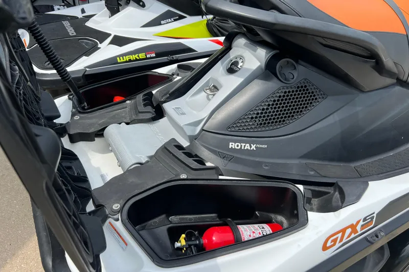 Slide: The Image of 2015 Sea-Doo Wake Pro 215 jet ski with storage compartments and fire extinguisher. - 15