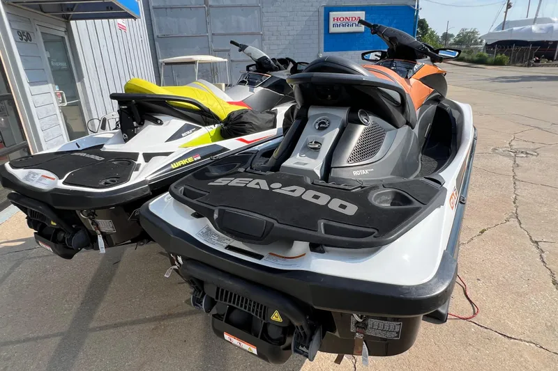 Slide: The Image of 2015 Sea-Doo Wake Pro 215 jet skis parked outside a marine shop. - 7