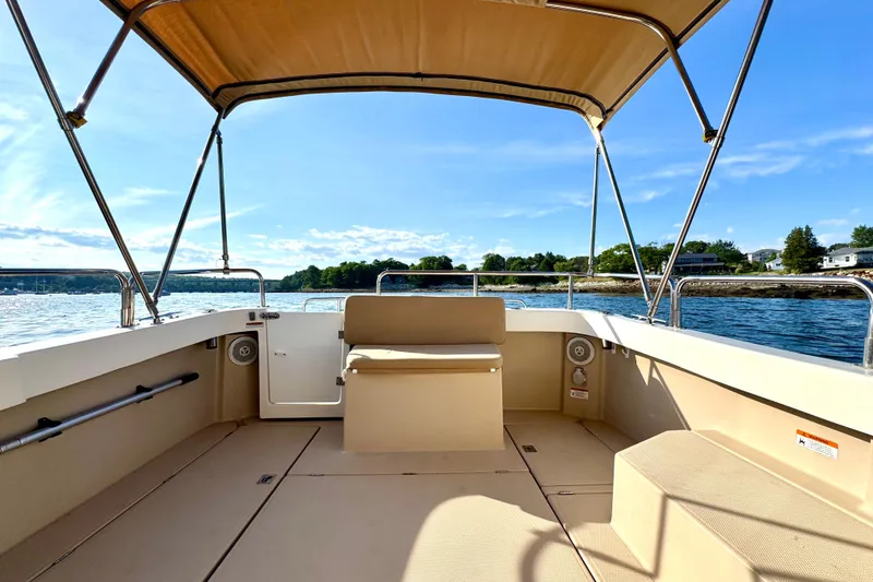 Slide: The Image of 2012 Ranger 27 boat interior with canopy, cruising on a sunny day. - 12