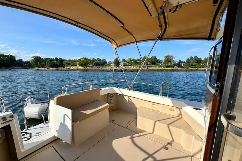 Slide: The Image of Interior view of 2012 Ranger 27 boat with canopy, overlooking scenic shoreline. - 14