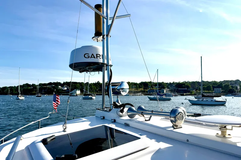 Slide: The Image of Ranger 27 boat on serene water with sailboats and clear blue sky, 2012 model. - 18