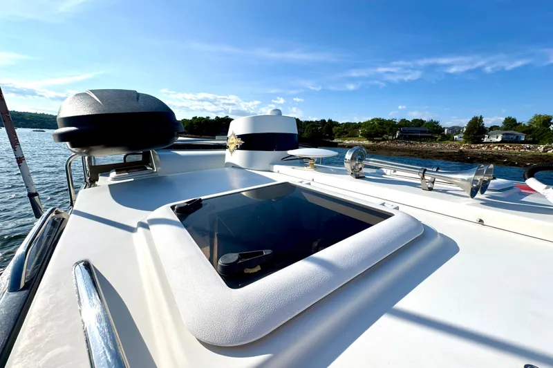Slide: The Image of 2012 Ranger 27 boat deck with hatch, horn, and scenic waterfront view. - 20