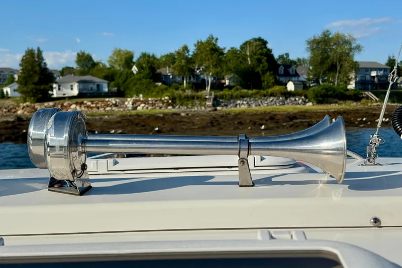 Slide: The Image of Chrome boat horn on 2012 Ranger 27, with coastal homes in the background. - 22