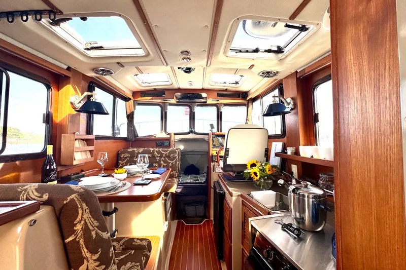 Slide: The Image of Luxurious 2012 Ranger 27 boat interior with elegant dining and kitchen area. - 24