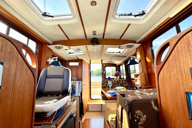 Slide: The Image of Luxurious interior of 2012 Ranger 27 boat with elegant wood finish and modern amenities. - 29