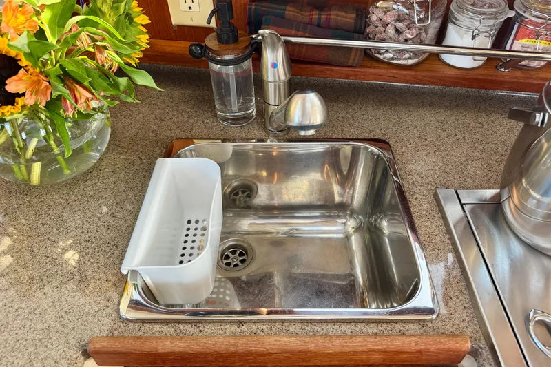 Slide: The Image of Stainless steel sink on Ranger 27 boat with flowers and kitchen accessories. - 36