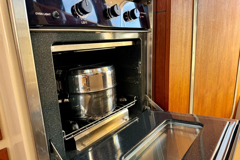 Slide: The Image of Stainless steel pot inside Ranger 27 oven, 2012 model, with wooden cabinetry. - 38