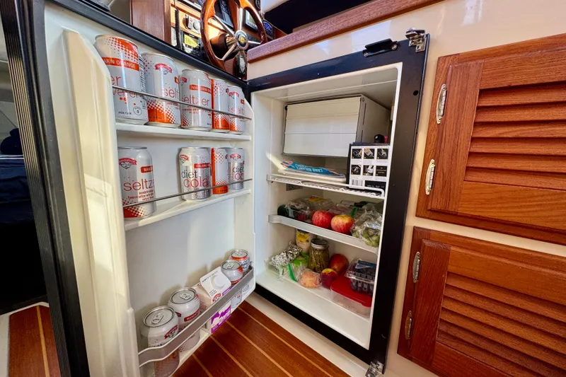 Slide: The Image of Mini fridge on Ranger 27 boat, stocked with drinks and fresh produce, 2012 model. - 41