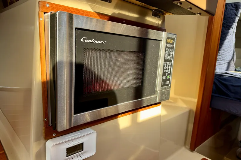 Slide: The Image of Microwave in 2012 Ranger 27 boat interior, featuring Contoure brand and digital controls. - 42