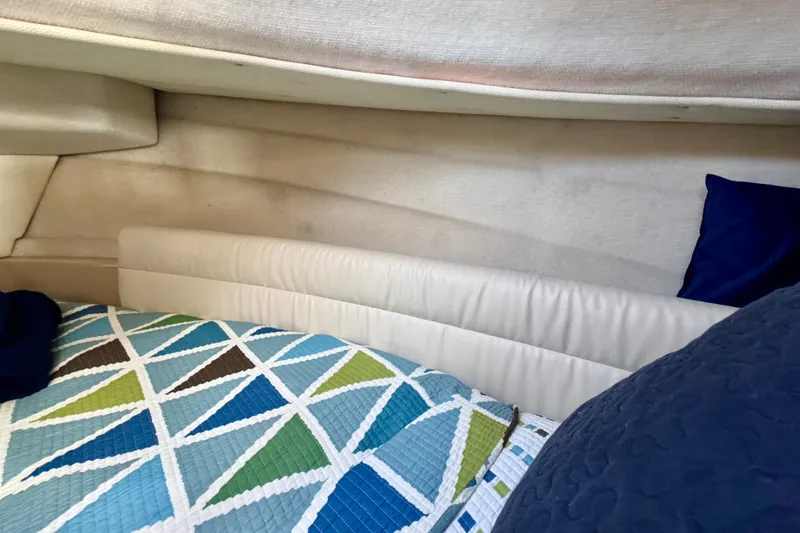 Slide: The Image of Cozy interior cabin of 2012 Ranger 27 boat with colorful geometric bedding. - 48