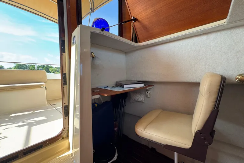 Slide: The Image of Interior of 2012 Ranger 27 boat with desk and chair setup. - 51