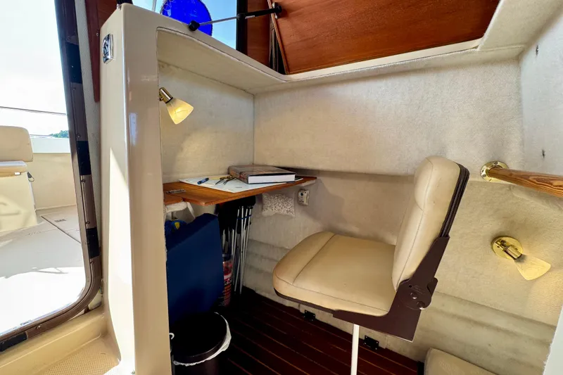 Slide: The Image of Cozy Ranger 27 boat interior with desk, chair, and reading lamp, 2012 model. - 52