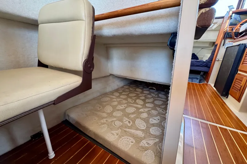 Slide: The Image of Interior of 2012 Ranger 27 boat with cozy sleeping area and wooden flooring. - 54