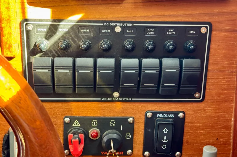 Slide: The Image of Control panel of a 2012 Ranger 27 boat with switches for wipers, fans, and lights. - 64