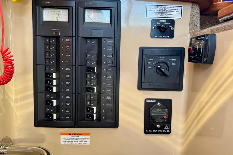 Slide: The Image of Control panel of a 2012 Ranger 27 boat with switches and meters. - 66
