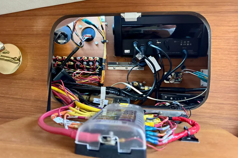 Slide: The Image of Electrical panel with wiring inside a 2012 Ranger 27 boat. - 67
